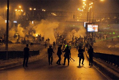 Egyptian supporters of the deposed Egyptian president Mohamed Morsi (back) clash with riot police in Cairo early on July 27, 2013. Mass rallies by supporters and opponents of Mohamed Morsi swept Egypt Friday, as the authorities formally detained the ousted Islamist president accusing him of conspiring with the Palestinian group Hamas. AFP PHOTO (Photo credit:STR/AFP/Getty Images)