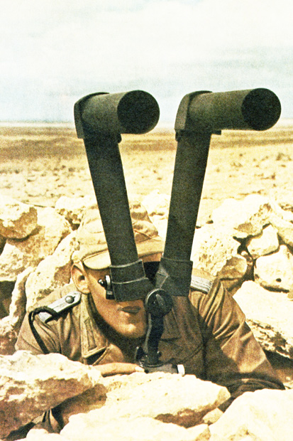 A German soldier in the Western Desert in 1942 scans the horizon for enemy movements