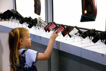 Fatal attraction: a four-year-old picks her favourite handgun at the NRA’s annual meeting in Milwaukee, 2006