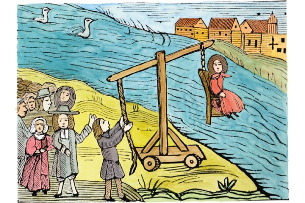 A woman on a ducking-stool, accused of witchcraft. Drowning would have proved her innocence